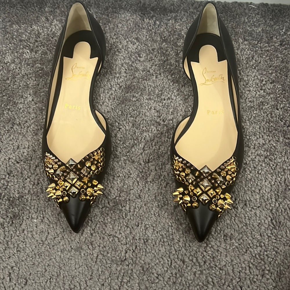 Christian Louboutin spike leather flats. Brand new. Never worn, only tried on.